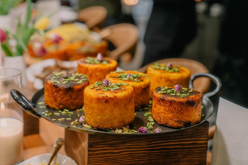 Garnished saffron tahchin cakes on a serving platter